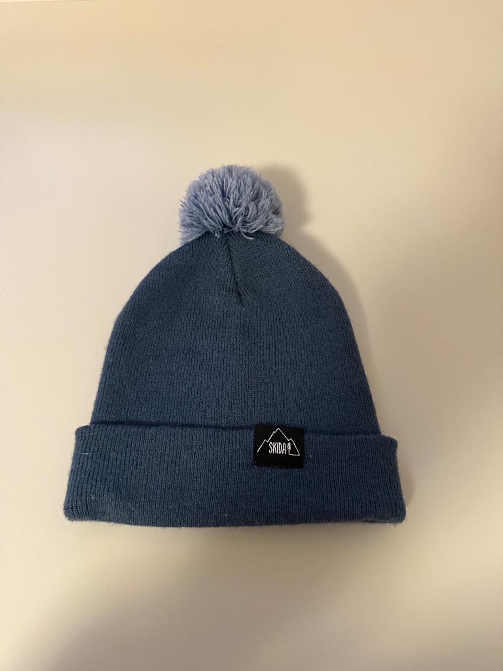 Skida Firetower Pom Beanie Hat in Blue